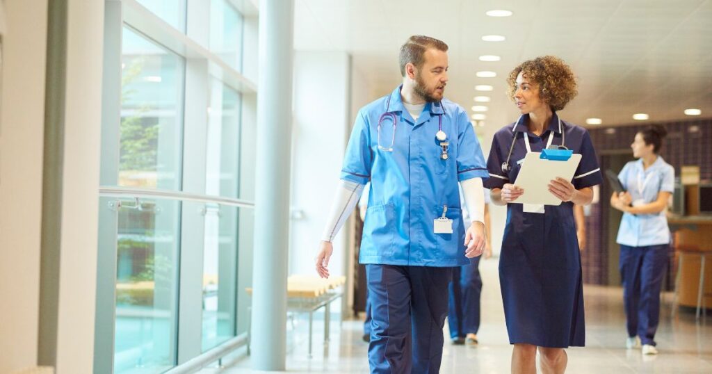 Male and female nurse engaging in conversation while walking, discussing the 5 major mistakes when dealing with the BRN.
