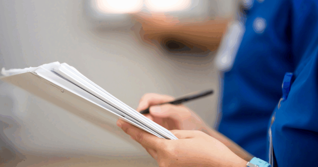 A nurse documenting something on paper.