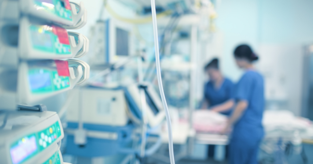 Two nurses tending to a patient, exercising their licenses as Registered Nurses.