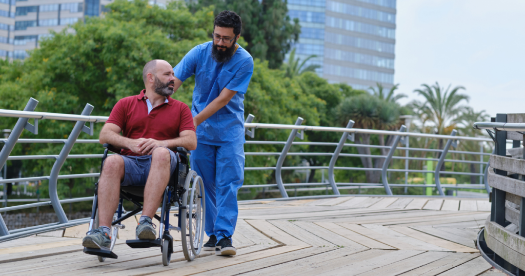 Male nurse helping a male patient in a wheelchair